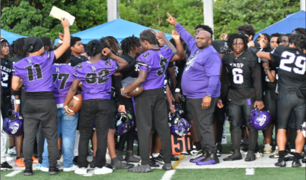 TEAMWORK: Coach Vernon Wilder III, leading his team during a huddle in a
game against Miami Killian Senior High School.